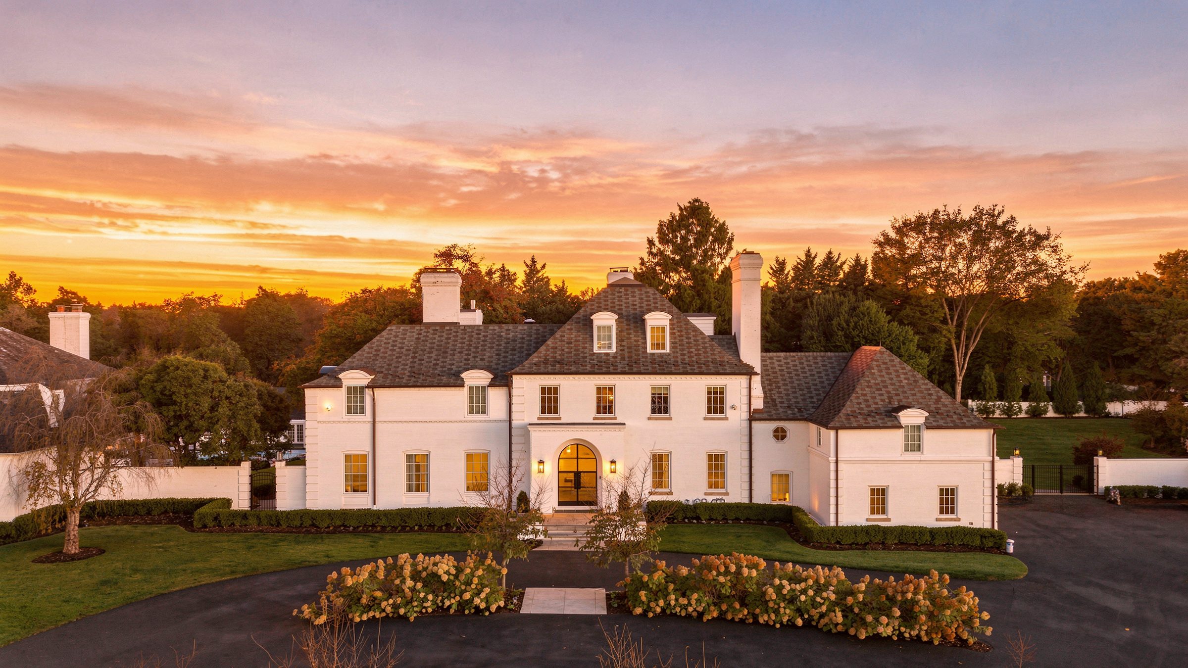The main house at dusk, lit from within