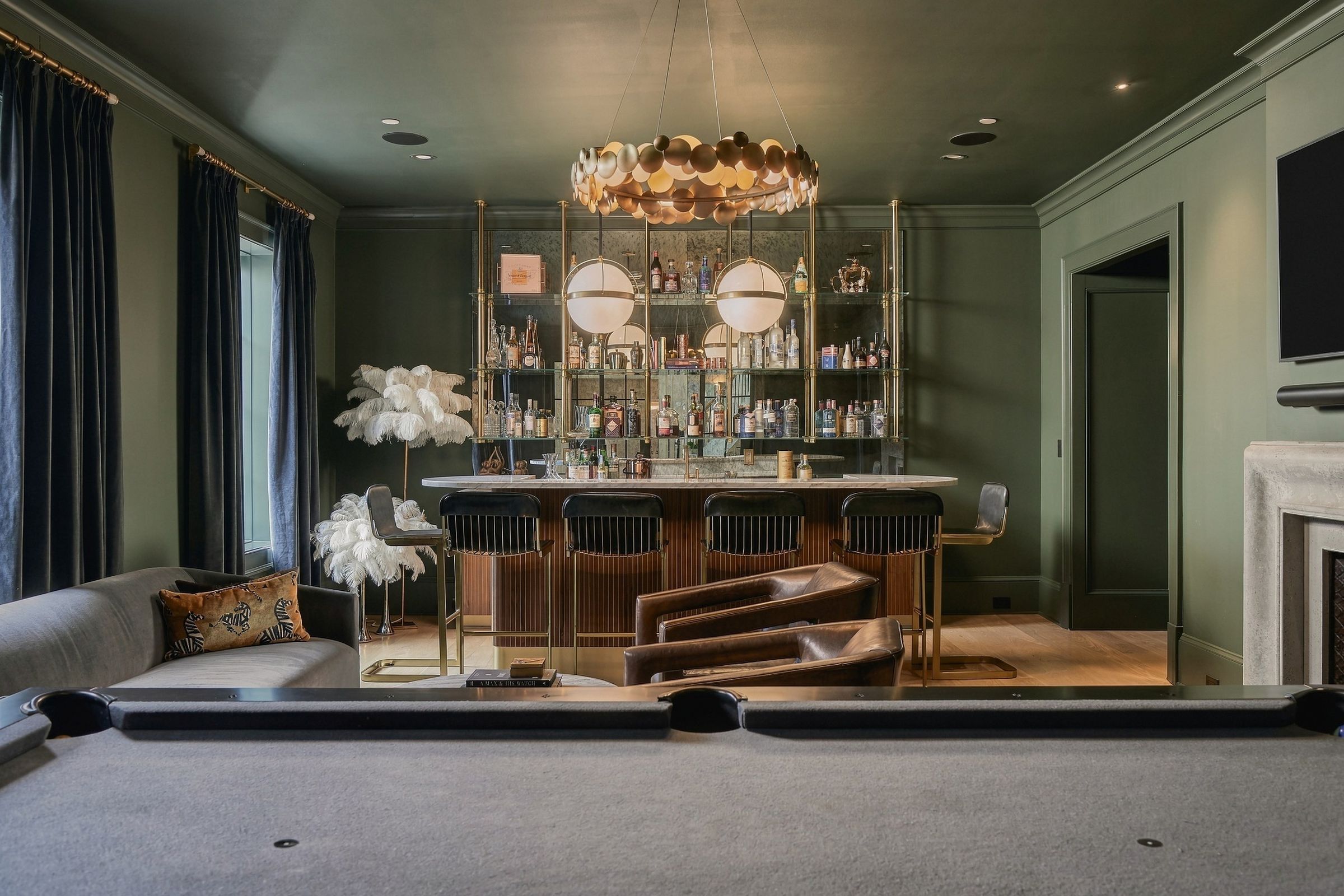 The speakeasy, with its marble-topped bar and brass and glass shelving