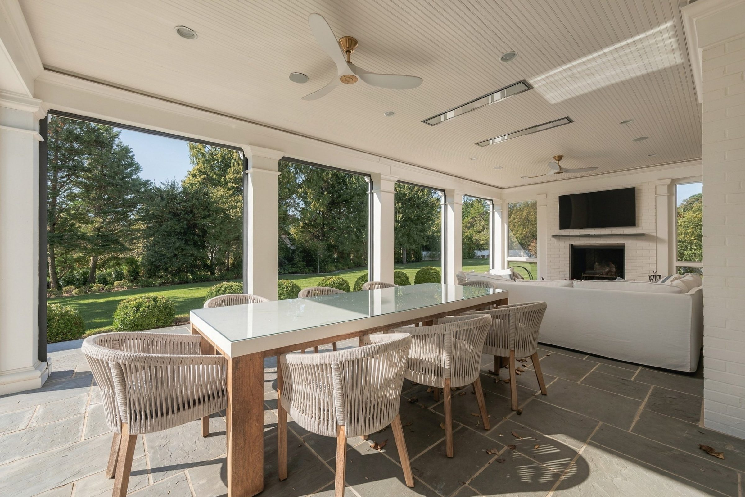 Screened porch dining table overlooking the lawn