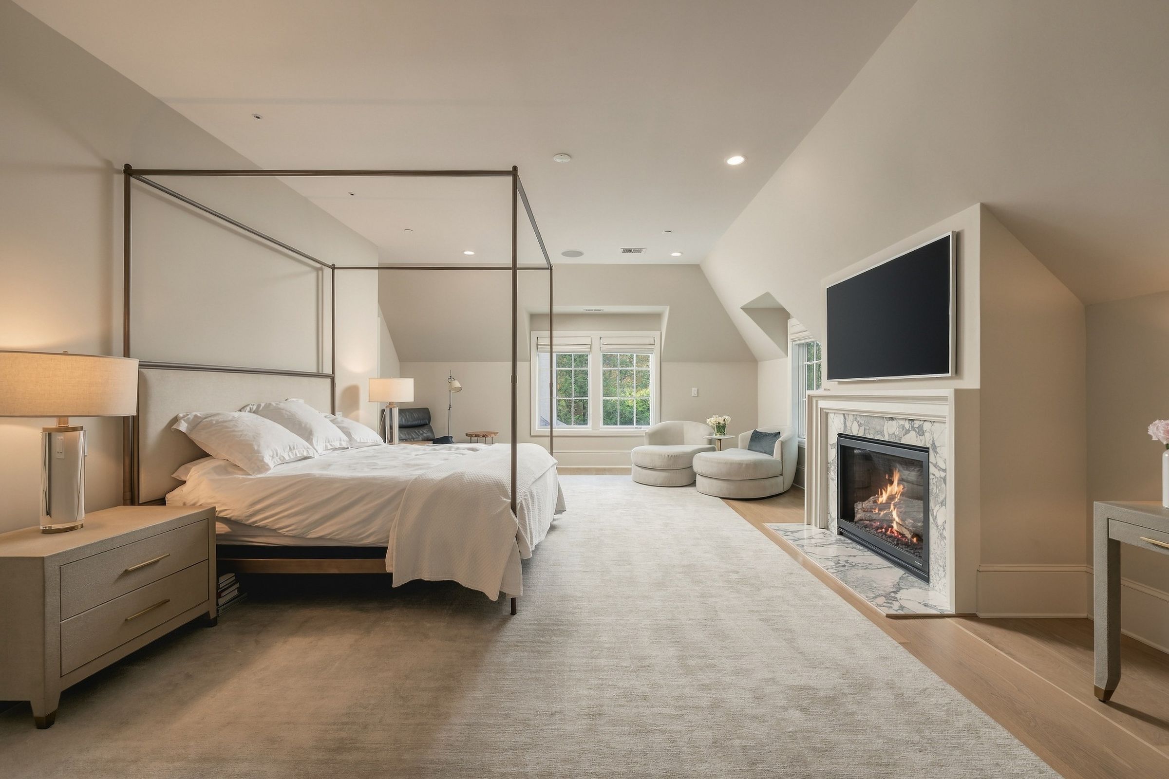 Primary bedroom with sitting area and fireplace
