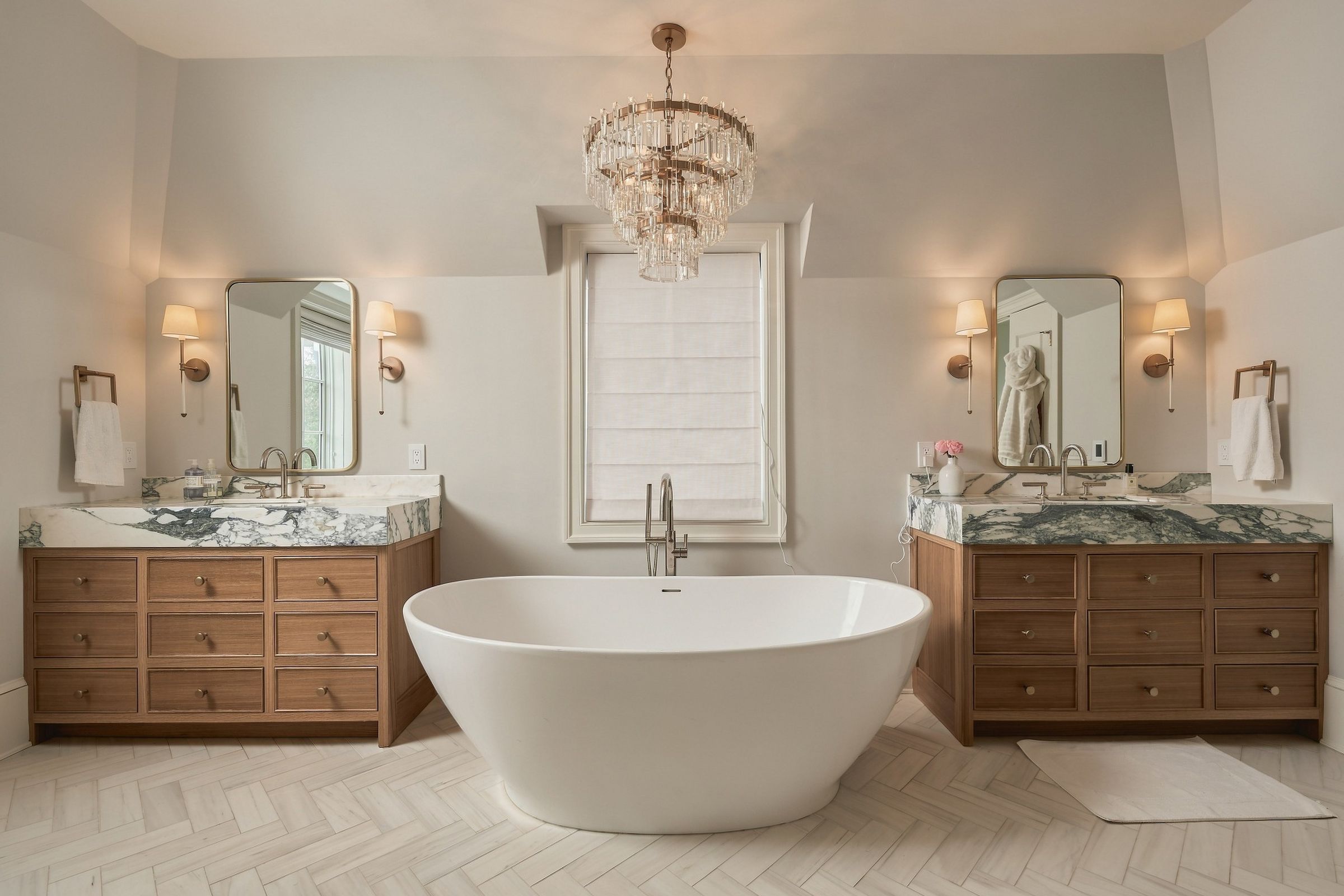 Marble primary bath with freestanding tub and twin vanities